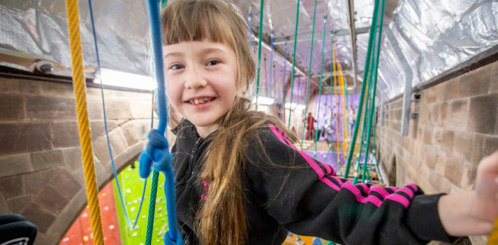A girl on the air walk course at Alter Rock