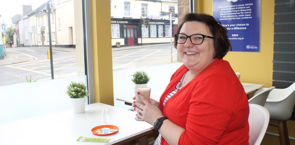 A volunteer in the CHICKS shop in Exeter, Devon