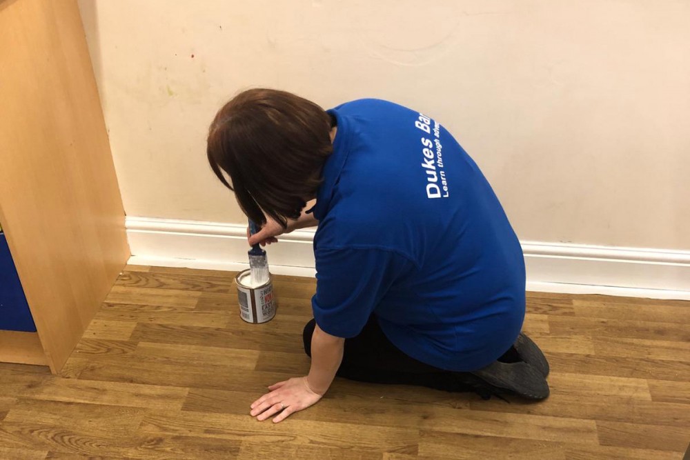 Dawn painting a wall in the dining room