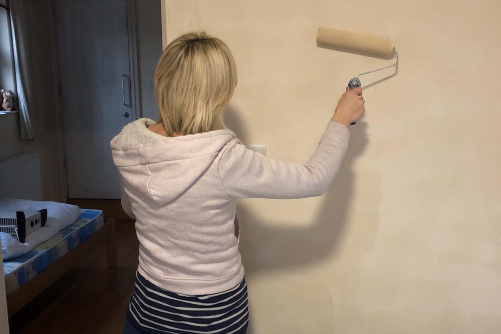 Karen painting one of the bedrooms