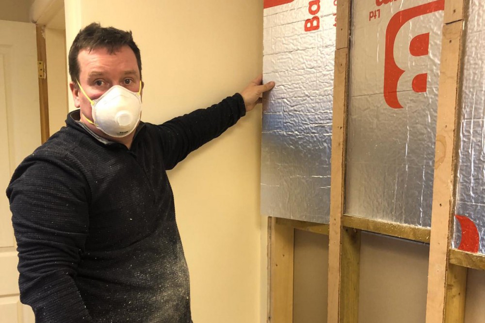 Paul installing some insulation